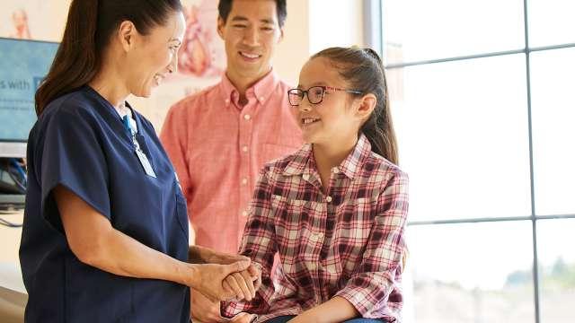 Nurse with pediatric patient and paren