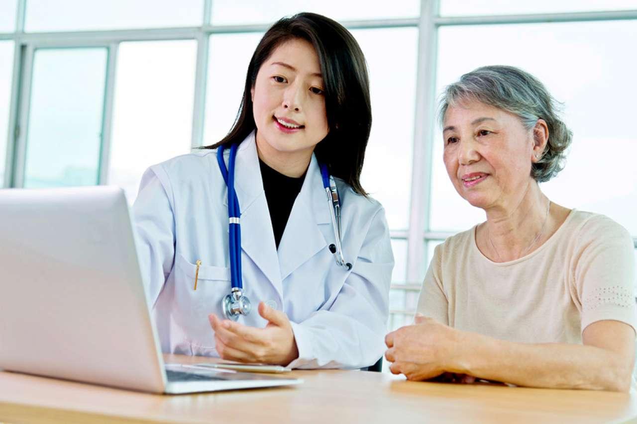 Doctor with patient and laptop